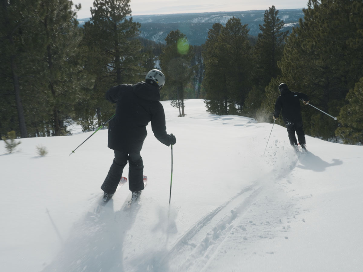 Two people skiing at Deer Mountain Village.