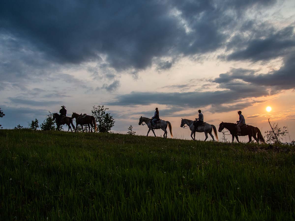 Horsebacking riding at sunset.